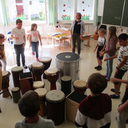 Kinder im Kreis beim Trommeln