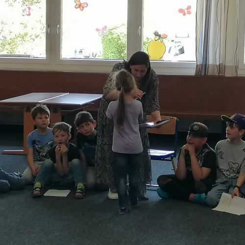 Kind aus 1. Klasse übergibt Lehrerin ein Abschiedsgeschenk